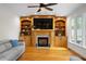 Inviting living room boasts a cozy fireplace, custom built-ins, and gleaming hardwood floors at 132 Wheatsbury Dr, Cary, NC 27513