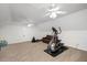 Spacious living room area with fitness equipment and ceiling fans at 132 Wheatsbury Dr, Cary, NC 27513