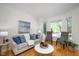 Cozy living room featuring hardwood floors, a comfortable sofa, and an abundance of natural light at 132 Wheatsbury Dr, Cary, NC 27513