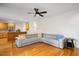 Spacious living room features a comfortable sectional sofa, hardwood floors, and a ceiling fan at 132 Wheatsbury Dr, Cary, NC 27513