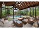 Inviting outdoor living space featuring comfortable seating, a grill, and a view of the pool at 132 Wheatsbury Dr, Cary, NC 27513