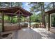 Inviting outdoor lounge with wicker furniture, a grill, and pool views at 132 Wheatsbury Dr, Cary, NC 27513