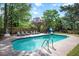 Sparkling in-ground pool with lounge chairs and a slide surrounded by a wooden fence at 132 Wheatsbury Dr, Cary, NC 27513