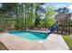 Backyard pool featuring a slide, lounge chairs and lush landscaping at 132 Wheatsbury Dr, Cary, NC 27513