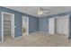 Bedroom with en suite bathroom, closet, carpeted floor, ceiling fan and light blue walls at 1323 Fairmont St, Durham, NC 27713