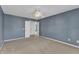 Bedroom featuring blue walls, carpeted floor, and a closet at 1323 Fairmont St, Durham, NC 27713
