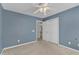 Bedroom featuring blue walls, ceiling fan, carpeted floor, and a closet at 1323 Fairmont St, Durham, NC 27713