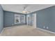 Bedroom with blue walls, carpeted floor, ceiling fan and large windows at 1323 Fairmont St, Durham, NC 27713