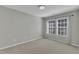 Bedroom with gray walls, carpeted floor, and large windows at 1323 Fairmont St, Durham, NC 27713
