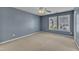 Bedroom with light blue walls, carpeted floor, ceiling fan and large windows at 1323 Fairmont St, Durham, NC 27713