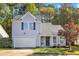 Charming home with grey siding, black shutters, garage, and a beautifully landscaped front yard at 1323 Fairmont St, Durham, NC 27713