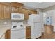 Kitchen with white appliances, wood cabinets, laminate counters, and wood flooring at 1323 Fairmont St, Durham, NC 27713