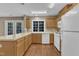 Efficient kitchen with white appliances, wood cabinets, ample counter space, and durable wood floors at 1323 Fairmont St, Durham, NC 27713