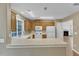 A cozy kitchen with updated appliances, cabinets, and a view into the adjacent fireplace at 1323 Fairmont St, Durham, NC 27713