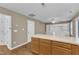 Kitchen island features wood cabinets and laminate counters; leads to living area with built-in at 1323 Fairmont St, Durham, NC 27713
