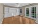 Living area features built-in shelving, wood floors, and French doors to the outside at 1323 Fairmont St, Durham, NC 27713
