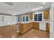 Kitchen island, dining, and living areas flow together with wood floors and white built-ins at 1323 Fairmont St, Durham, NC 27713