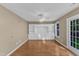 Living area featuring built-in shelving, wood floors, and access to the outside at 1323 Fairmont St, Durham, NC 27713