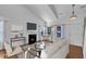 Bright living room boasts a fireplace, neutral decor, and large windows offering ample natural light at 1323 Fairmont St, Durham, NC 27713