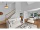 Staged living room features wood floors, staircase, neutral decor, and an open floorplan at 1323 Fairmont St, Durham, NC 27713