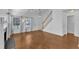 Open-concept living room features wood floors, large windows, and a staircase to the upper level at 1323 Fairmont St, Durham, NC 27713
