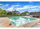 Community swimming pool with clear water and surrounding green trees at 1323 Fairmont St, Durham, NC 27713