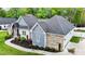Aerial view of a home with brick and siding exterior, showcasing its well-maintained roof and landscaping at 1325 George Bason Rd, Graham, NC 27253