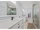 Bathroom featuring double vanities with marble countertops, modern fixtures, and glass-enclosed shower at 1325 George Bason Rd, Graham, NC 27253
