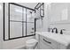 Modern bathroom featuring a shower-tub combination with subway tile and sleek black fixtures at 1325 George Bason Rd, Graham, NC 27253