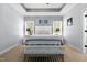 Cozy bedroom with neutral tones, a bed with striped bedding, bedside tables, and decorative wall art at 1325 George Bason Rd, Graham, NC 27253