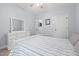 Peaceful bedroom with a striped bedspread, white dresser, and neutral paint at 1325 George Bason Rd, Graham, NC 27253