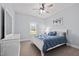 Serene bedroom featuring a white bed with blue bedding and a matching dresser at 1325 George Bason Rd, Graham, NC 27253