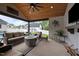 Spacious covered patio with a lounge area, fire pit, TV, and stylish decor at 1325 George Bason Rd, Graham, NC 27253