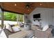 Relaxing covered patio area with comfortable seating, a fire pit, and outdoor decor at 1325 George Bason Rd, Graham, NC 27253