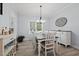 Bright dining room with a wooden table, white chairs, and light blue walls at 1325 George Bason Rd, Graham, NC 27253