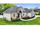Beautiful home with brick and siding, complemented by lush landscaping and a paved walkway to the front door at 1325 George Bason Rd, Graham, NC 27253
