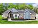 Beautiful single-story home featuring brick, light-blue siding, and a landscaped yard at 1325 George Bason Rd, Graham, NC 27253