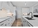 Well-lit kitchen featuring white cabinets, a central island, and modern appliances at 1325 George Bason Rd, Graham, NC 27253