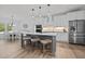 Bright kitchen with white cabinets, a gray island, and stainless steel appliances at 1325 George Bason Rd, Graham, NC 27253