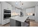 Spacious kitchen with white cabinetry, quartz counters, and stainless steel appliances at 1325 George Bason Rd, Graham, NC 27253