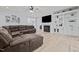 Inviting living room featuring a fireplace, built-in shelving, and a large, comfortable leather sectional sofa at 1325 George Bason Rd, Graham, NC 27253