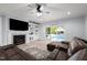 Cozy living room with a fireplace and built-in shelving, leading to a backyard pool area at 1325 George Bason Rd, Graham, NC 27253