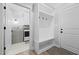 Bright mudroom and laundry area with hall tree, white cabinets, and access to laundry machines at 1325 George Bason Rd, Graham, NC 27253