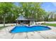 A beautiful pool featuring a poolhouse with outdoor seating and well-manicured landscaping, creating a backyard oasis at 1325 George Bason Rd, Graham, NC 27253