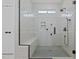 Glass-enclosed shower with subway tile walls, black fixtures, and a built-in shower bench at 1325 George Bason Rd, Graham, NC 27253
