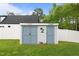 Backyard storage shed with double doors and decorative palm tree accent at 1325 George Bason Rd, Graham, NC 27253