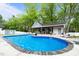 Beautiful in-ground swimming pool with a pool house and lounge chairs at 1325 George Bason Rd, Graham, NC 27253