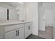 Modern bathroom with dual sinks, white cabinetry, and a large mirror at 135 Carlton Ln, Franklinton, NC 27525