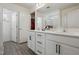 Bathroom with dual vanity sinks, modern fixtures, and a walk-in closet at 135 Carlton Ln, Franklinton, NC 27525