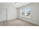 Well-lit, carpeted bedroom with large windows at 135 Carlton Ln, Franklinton, NC 27525